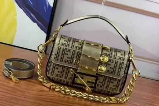 Fendi Baguette Bag Gold with oversized buckle and chain strap – iconic FF canvas handbag with luxury golden details.