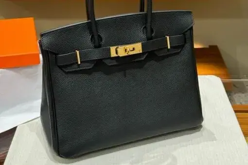 Hermes Birkin 30 Bag Black in Togo leather with gold hardware – iconic luxury handbag symbol of elegance and exclusivity.