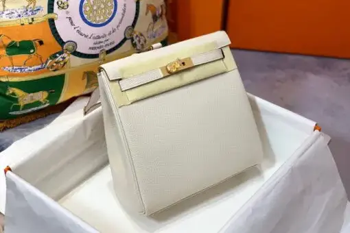 Hermes Kelly Ado Backpack White in Togo leather with gold hardware – a luxury backpack inspired by the iconic Hermes Kelly Bag.
