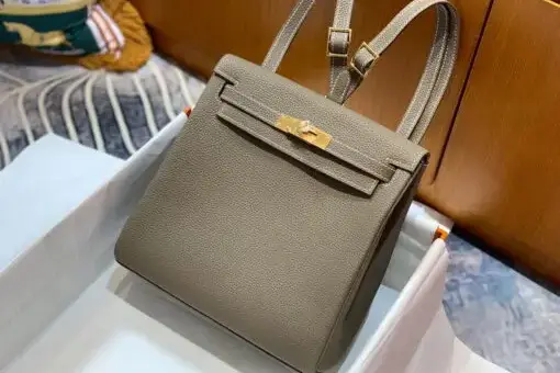 Hermès Kelly Ado Backpack Étoupe in Togo leather with gold hardware – a luxury backpack inspired by the iconic Hermès Kelly Bag.